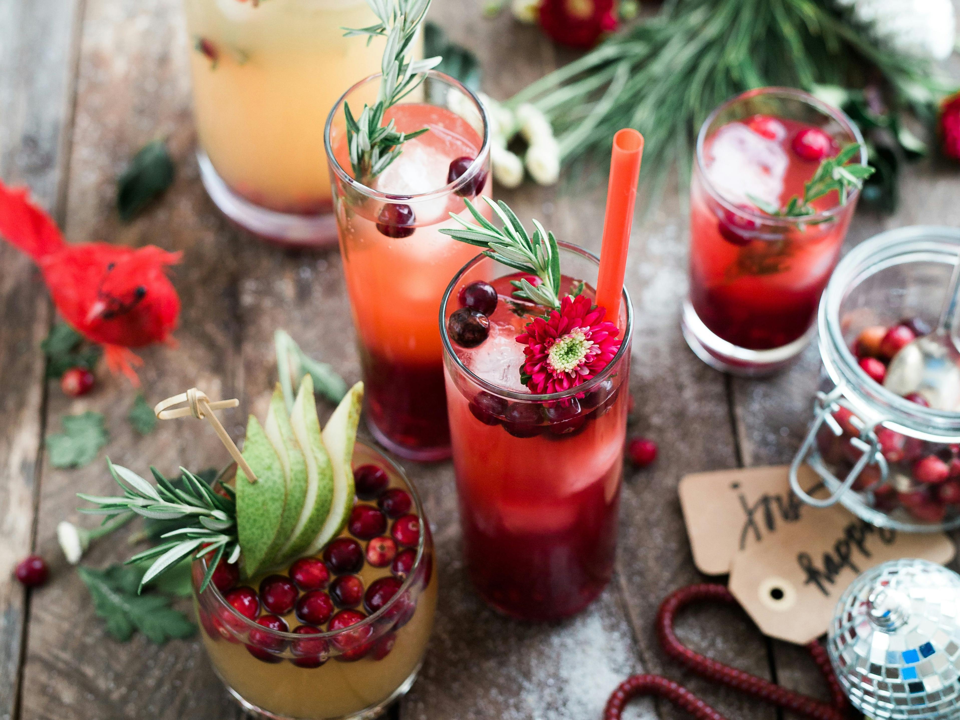 Close-up of festive, brightly colored drinks on a wooden table.